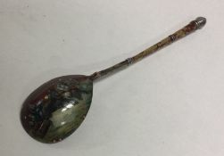 A Russian silver and enamelled spoon decorated wit