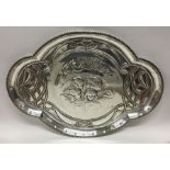 A large silver dressing table tray attractively de