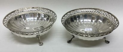A pair of pierced silver bonbon dishes with panell
