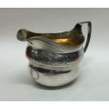 A good quality George III engraved silver cream ju