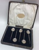 A cased set of six silver bean top coffee spoons.