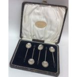 A cased set of six silver bean top coffee spoons.