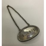 A heavy oval silver brandy label with beaded rim o