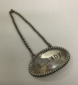 A heavy oval silver brandy label with beaded rim o