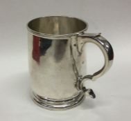 A heavy George II tapering silver mug on sweeping