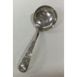 An Edwardian silver sifter spoon with thistle deco