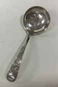 An Edwardian silver sifter spoon with thistle deco