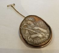 A stylish gold cameo brooch with safety chain. App