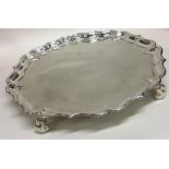 A heavy George II circular silver salver on three