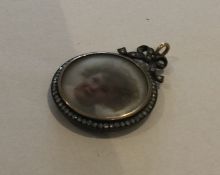 A circular rose diamond miniature locket / pendant