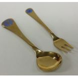 GEORG JENSEN: A silver gilt child's spoon together