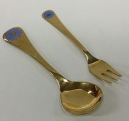 GEORG JENSEN: A silver gilt child's spoon together