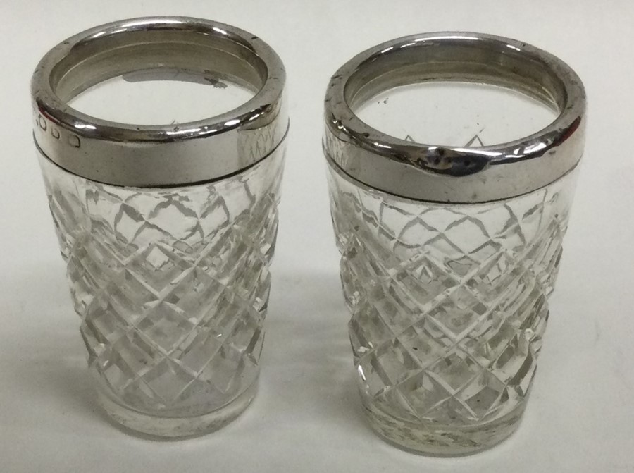 A pair of silver mounted and glass tapering beaker