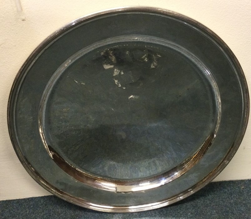 A massive circular Russian silver charger with ree