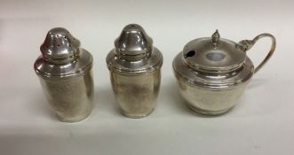 A silver three piece cylindrical cruet set. Birmin