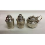 A silver three piece cylindrical cruet set. Birmin