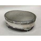 An engine turned silver hinged top jewellery box.