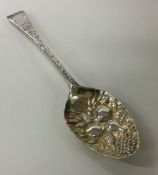 A George III silver berry spoon with chased decora