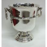 An Edwardian silver two handled ice bucket on swee