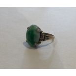 A good Chinese single stone ring with oval jade pa