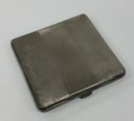 A heavy Art Deco silver compact of engine turned d