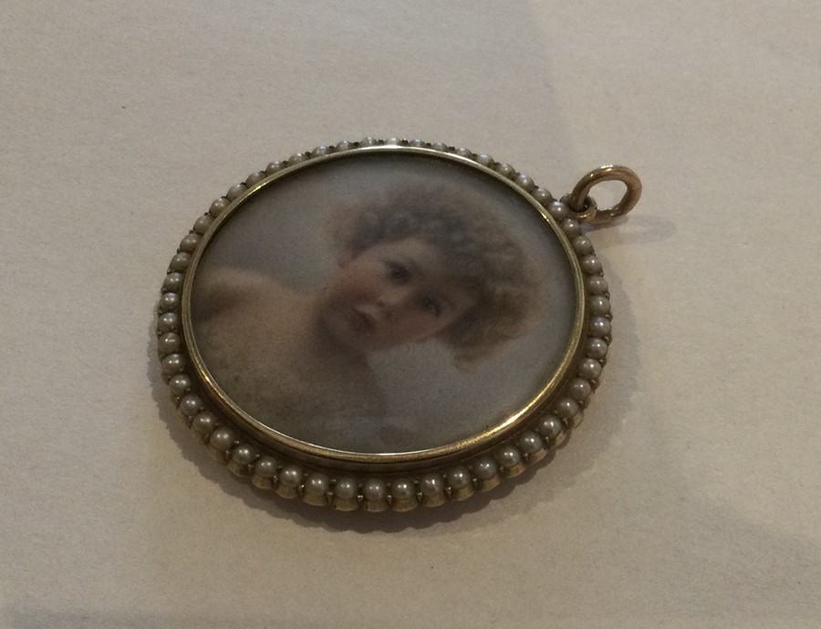 A circular half pearl and gold mounted miniature w