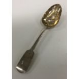 A heavy fiddle pattern silver berry spoon. London.