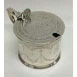A Victorian silver engraved mustard pot on reeded