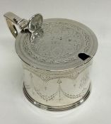 A Victorian silver engraved mustard pot on reeded