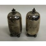 A pair of Edwardian silver cylindrical peppers. Bi