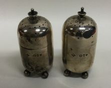 A pair of Edwardian silver cylindrical peppers. Bi