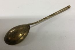 A Russian silver gilt spoon decorated with flowers