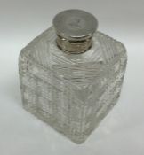 A silver and cut glass mounted scent bottle of squ