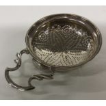 A Georgian silver lemon strainer. London. By GV. A