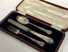 A cased silver three piece christening set. London