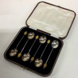 A cased set of six silver bean top coffee spoons.