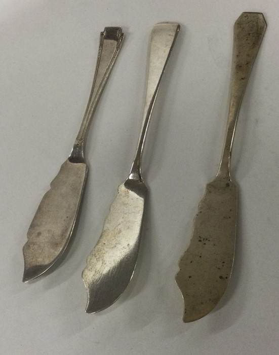 A heavy group of three silver butter knives of sty