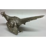 A heavy cast silver figure of a pheasant in standi