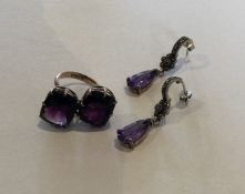 An amethyst crossover ring in gold frame together