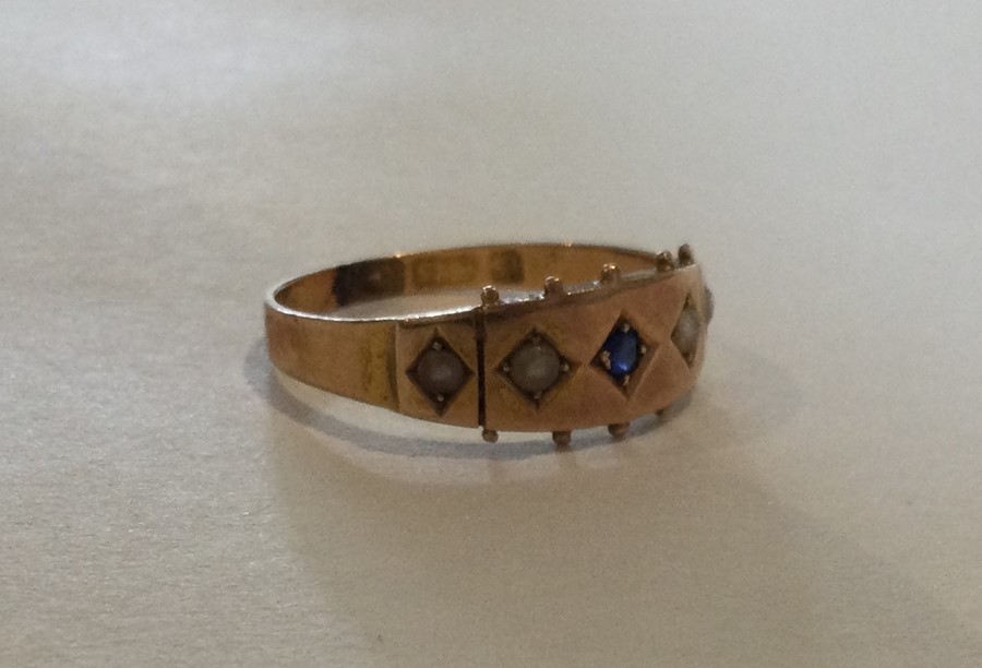 A 15 carat gold sapphire and pearl ring. Approx. 2