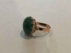 An 18 carat jade mounted single stone ring in claw