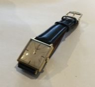 LONGINES: A gent's gold wristwatch with silvered d