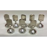 A good set of eight silver menu holders of circula