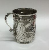 A chased silver christening cup decorated with flo