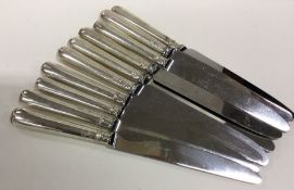 A heavy set of ten silver handled table knives of