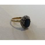 A sapphire and diamond cluster ring in 18 carat go