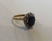 A sapphire and diamond cluster ring in 18 carat go