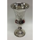 A tapering silver vase decorated with flowers. Lon