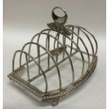A large seven bar silver toast rack with three scr