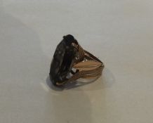 A gold framed ring mounted with a smokey quartz. A